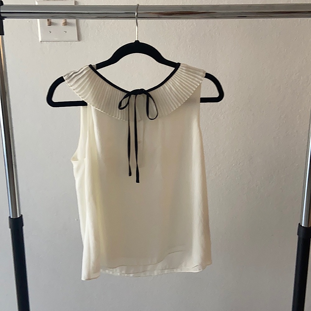 Zara, medium blouse with neck ruffles and black tie.